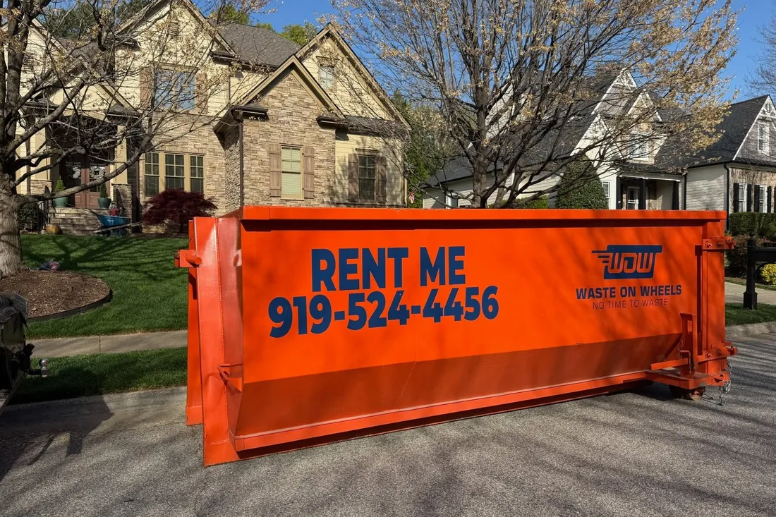 Waste On Wheels roll-off dumpster on a residential driveway in Raleigh, NC